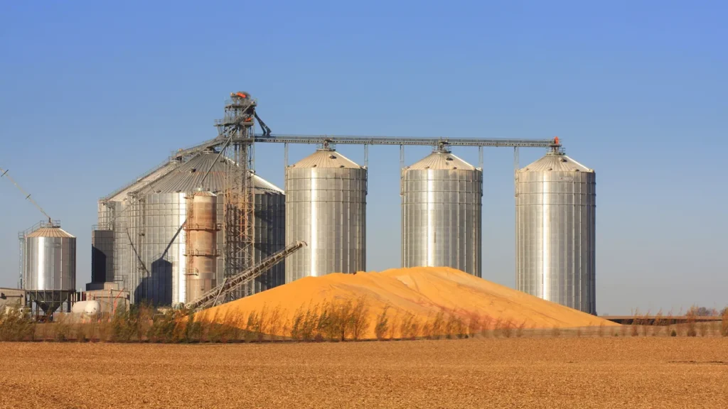 oil-1 grain bins and corn pile in iowa getty images